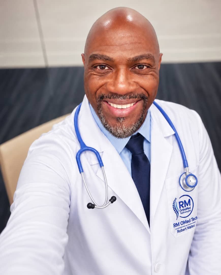 Portrait of Robert Mateo, founder and CEO of RM OrthoMed Technologies, in a white coat carrying the company logo.